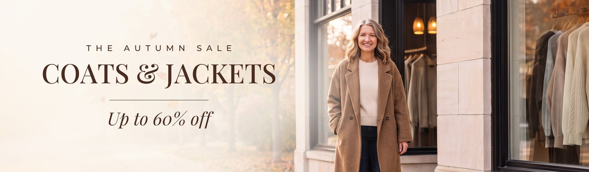 The Autumn Sale: Coats & Jackets, up to 60% off. Mae in front of the Linden & Mae boutique.